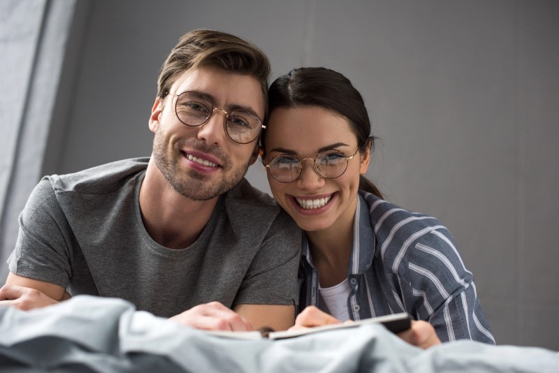 a man and woman smiling and looking at camera
