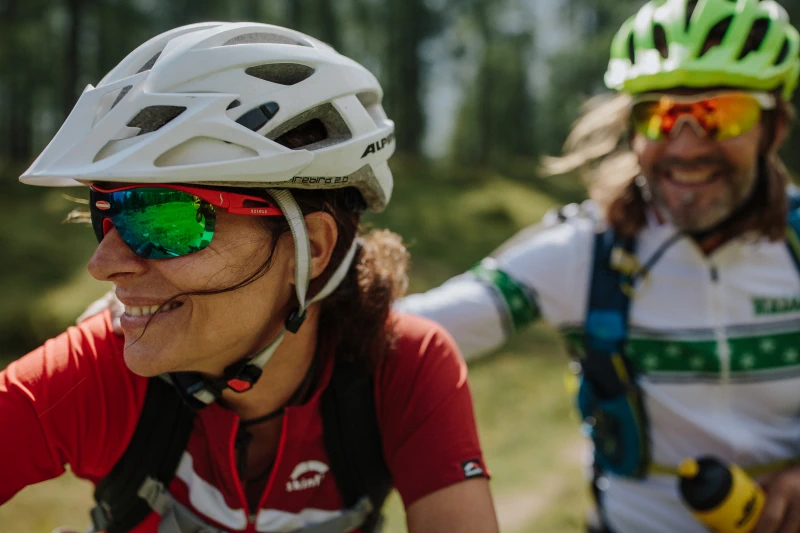a man and woman wearing helmets