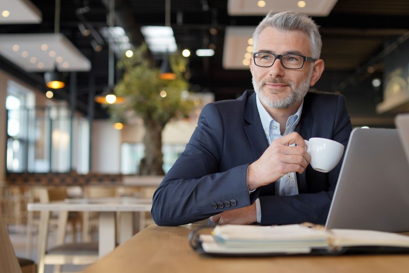 a man holding a cup of coffee