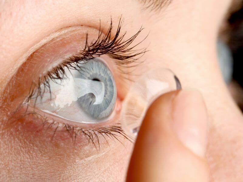 a person putting a contact lens in their eye